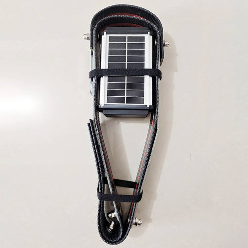 Manewise GPS tracker solar panel fitted into black strap harness
