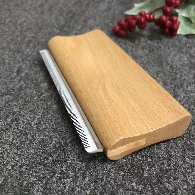 Manewise curry comb resting on fabric surface near red berries