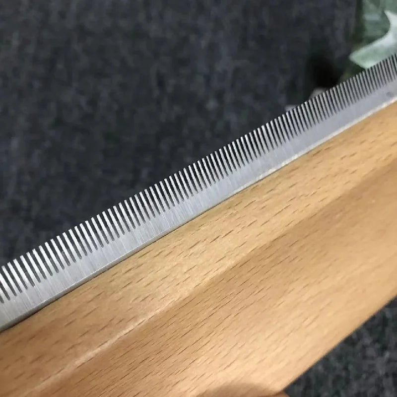Close-up of Manewise curry comb's metal shedding teeth along wooden edge