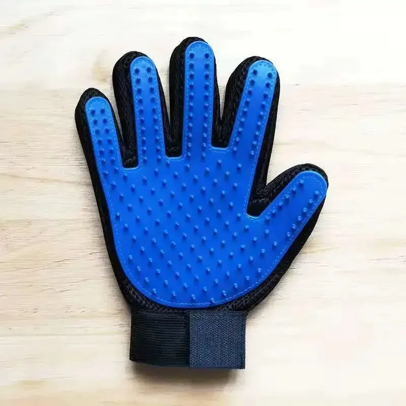 Manewise grooming glove on wood surface, palm view with blue bristles